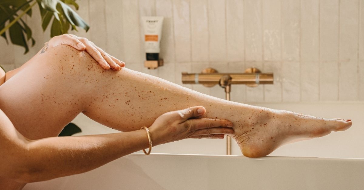 Une femme qui s'applique mon gommage sur les jambes